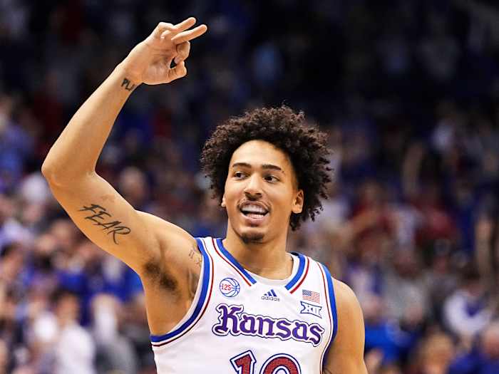 Kansas’s Jalen Wilson holds up three fingers.